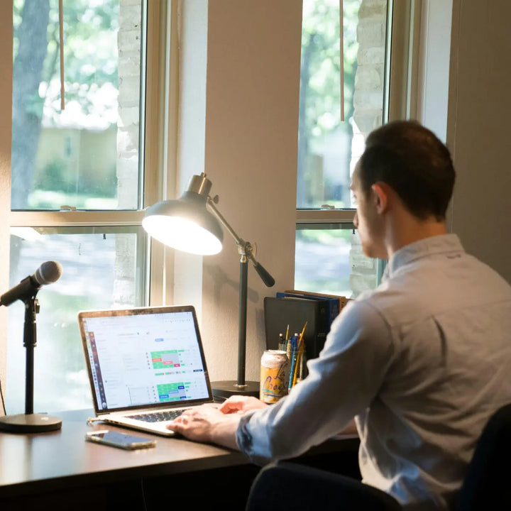 Man working at a desk while feeling mentally foggy and having trouble concentrating