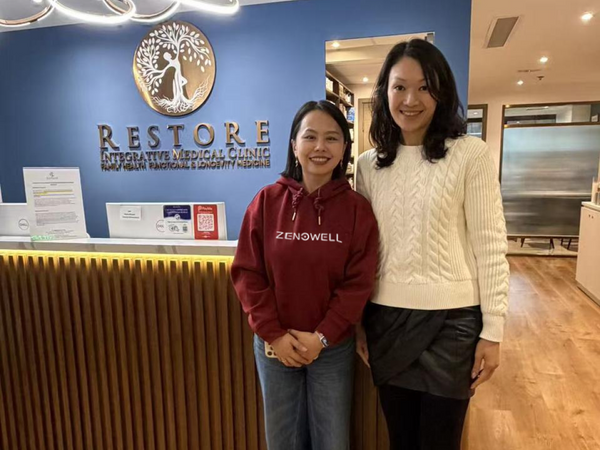 Zenowell team member with a partner at Restore Integrative Medical Clinic, highlighting a wellness collaboration.